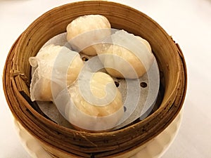 Steamed shrimp dumplings on bamboo basket, Ha gow, bamboo tray in the local tradional chinese food in China town with blur backgro