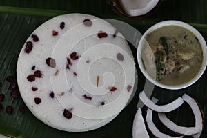 Steamed spongy rice cake topped with dried cranberries. Served with chicken stew