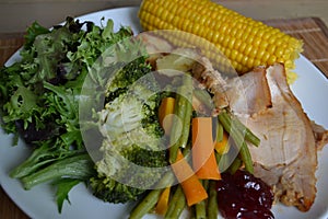 Steamed vegetable with sweet corn and roasted pork with cranberries sauce