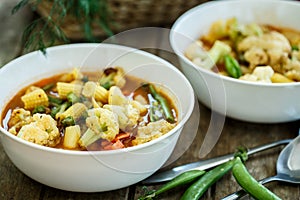 Steamed vegetables in a bowl on wooden table