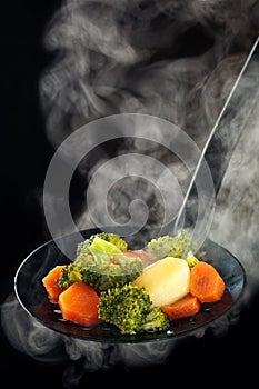 Steamed vegetables and steam.