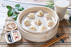 Steamed xiaolongbao served in a traditional steaming basket