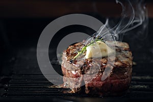 A steaming beef tenderloin steak is grilled