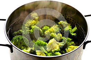 Vegan food : steaming broccoli in an inox pot photo