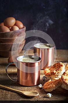 Steaming Coffee in Copper Cups with Biscuits