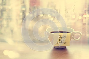 Steaming coffee cup with emotion message cup in coffee shop, front of mirror and raindrop window, Vintage color and soft concept