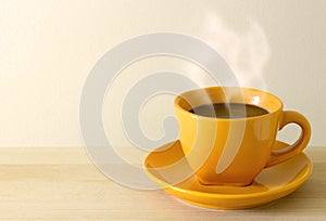 Steaming coffee cup on table