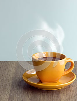 Steaming coffee cup on table photo