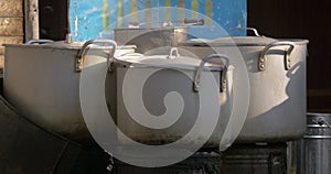 Steaming cooking pots in the street