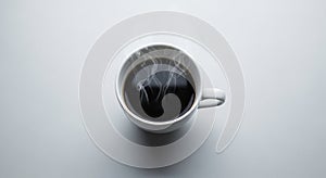 A steaming cup of black coffee in a white ceramic mug is centrally placed on a plain
