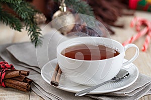 Steaming hot cup of tea with Christmas decorations