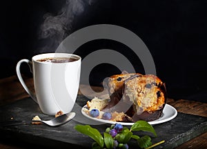 Steaming Hot Drink and Blueberry Muffins