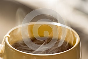 Steaming hot drink in cup close up view