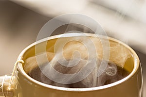 Steaming hot drink in cup close up view