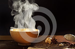 Steaming of hot food soup in a wooden bowl.