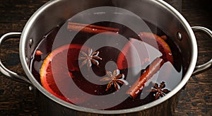 Steaming Mulled Wine with Spices in a Metal Pot