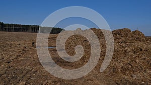 Steaming pile of manure on farm field in Dutch countryside