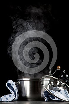 Steaming pot on black background