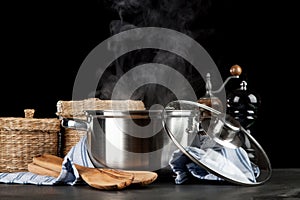 Steaming pot on black background