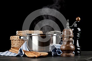 Steaming pot on black background