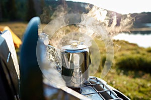 Steaming pot of coffee over a gas burner