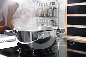 Steaming pot on electric stove in kitchen