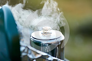 Steaming stainless steal coffee pot on a burner