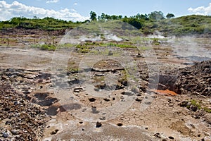 Steaming volcanic mud pots