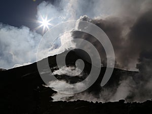 Steaming Volcano etna in Sicily in the morning sun photo