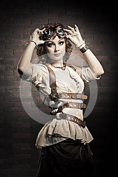 Steampunk girl with goggles. Old-fashioned.