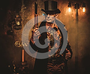 Steampunk man with gun on vintage steampunk background