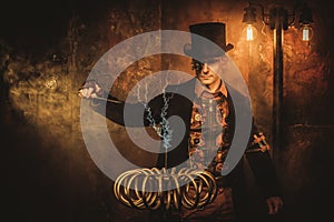 Steampunk man with Tesla coil on vintage steampunk background