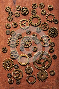 Steampunk mechanical cogs gears wheels on wooden background