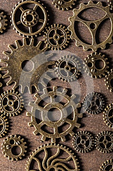 Steampunk mechanical cogs gears wheels on wooden background