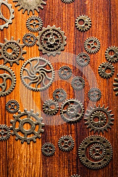 Steampunk mechanical cogs gears wheels on wooden background