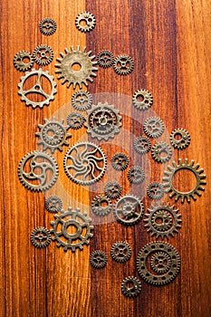 Steampunk mechanical cogs gears wheels on wooden background