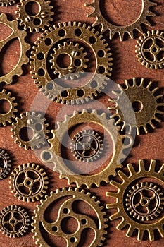 Steampunk mechanical cogs gears wheels on wooden background