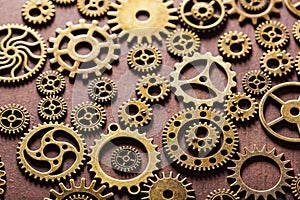 Steampunk mechanical cogs gears wheels on wooden background