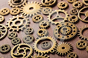 Steampunk mechanical cogs gears wheels on wooden background