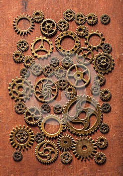 Steampunk mechanical cogs gears wheels on wooden background