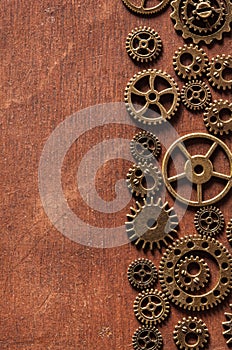 Steampunk mechanical cogs gears wheels on wooden background