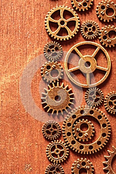 Steampunk mechanical cogs gears wheels on wooden background