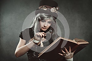 Steampunk woman with book and lens