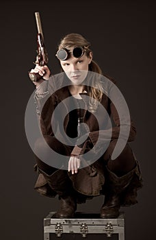 Steampunk woman wearing brown and holding a gun