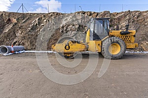 Steamroller performing road paving works