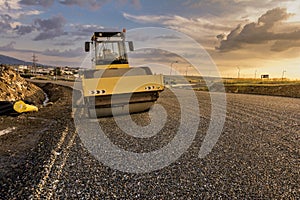 Steamroller performing road paving works