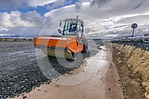 A steamroller on a road construction site