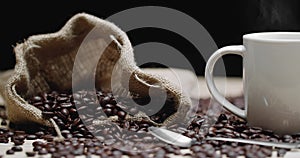 Steamy Cup and Bag of Coffee Seeds Closeup