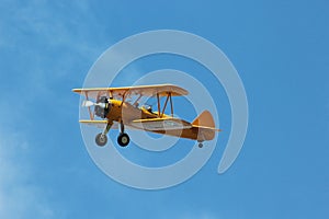 Stearman Biplane Flying Through Blue Skies