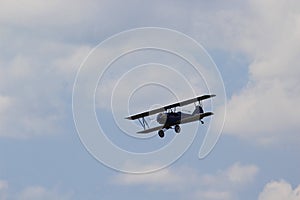 Stearman Biplane flying through the Clouds